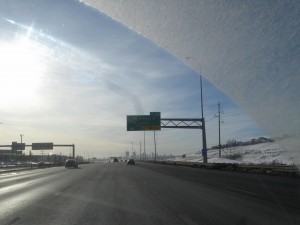 view of highway from inside a car with a dirty windshield