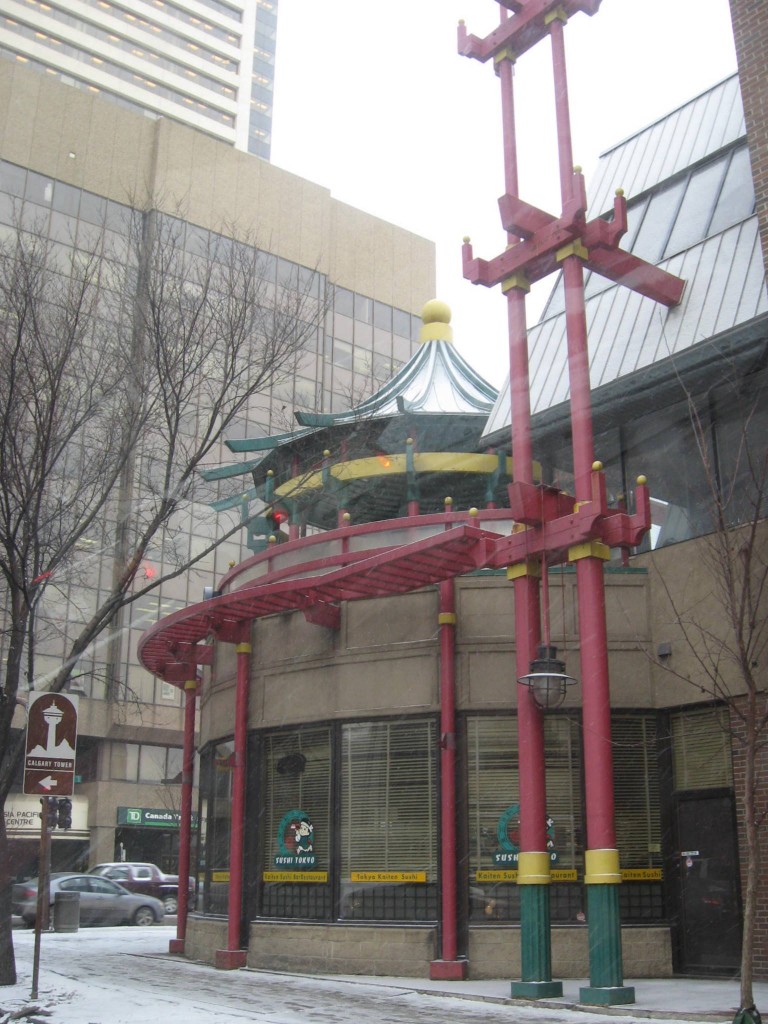 Red pillars and green and yellow roof of Chinese restaurant