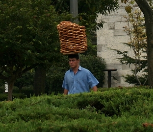 Guy carrying bread on his head
