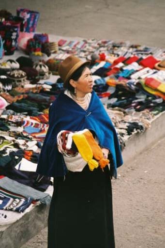 Woman selling souvenirs to tourists on top of the train