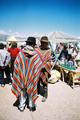 Local men are dressed in colourfully-striped rainbow ponchos